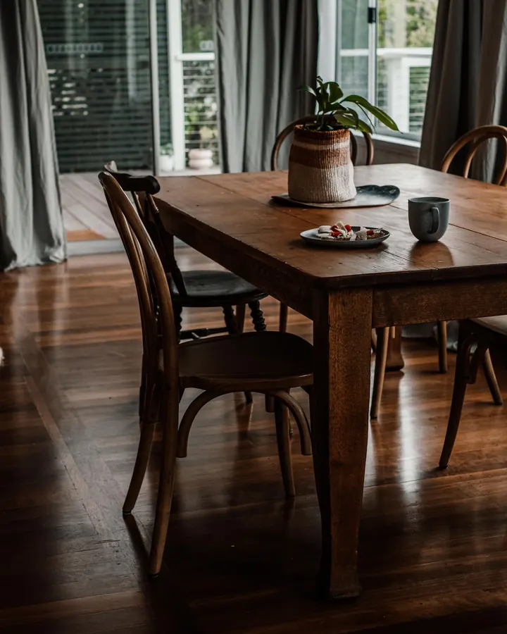 Dark wood dining table with matching bentwood chairs