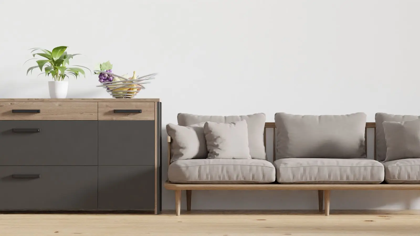 Low sofa beside a grey sideboard with plants on top